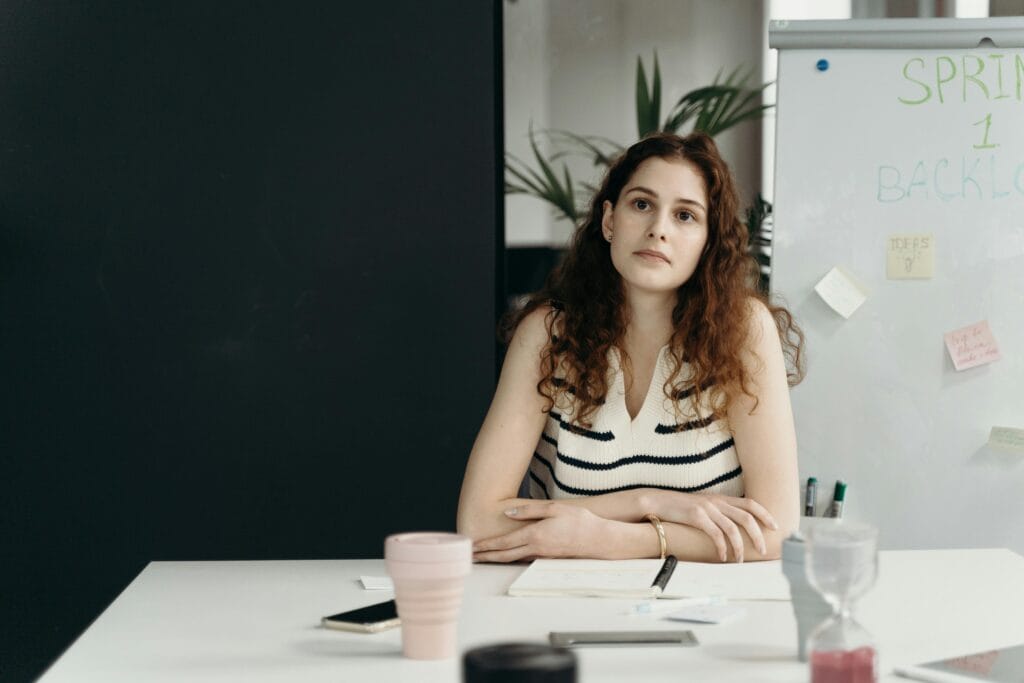 Employee experiencing burnout in a South African office setting during a project meeting